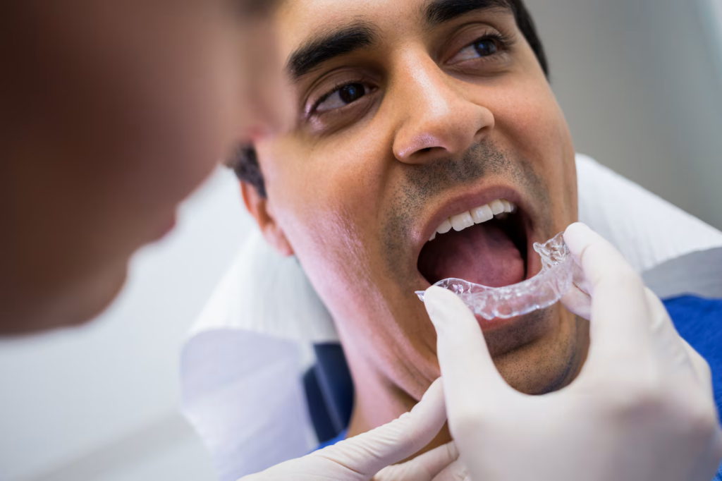 dentist assisting patient wear invisible braces